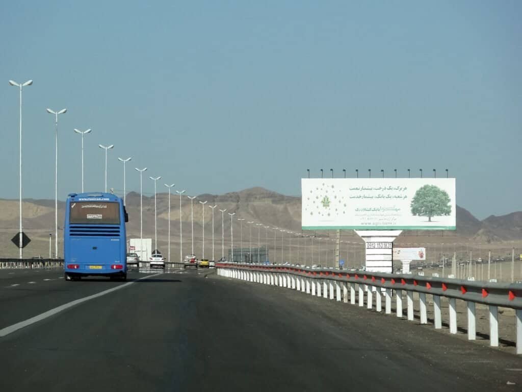 A metal highway crash barrier, used as a visual metaphor for guardrails that keep AI outputs safe, on-brand, and compliant