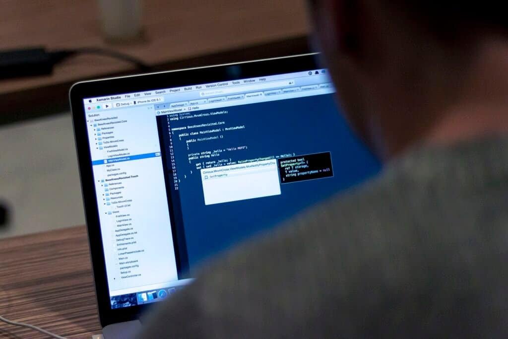 Person typing JSON-LD schema markup code on a laptop to add structured data to a website