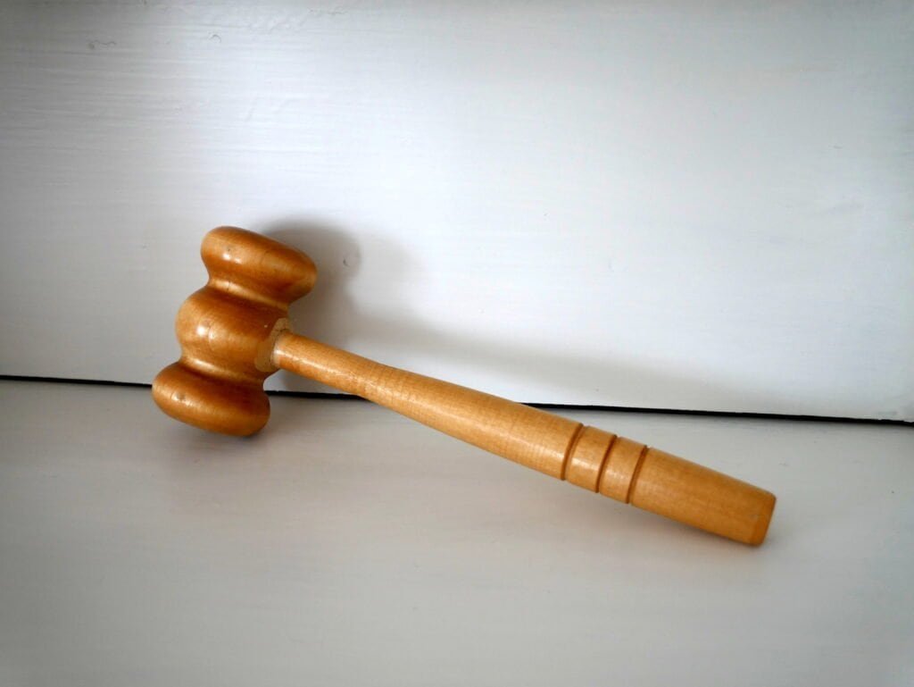 Wooden gavel on a desk, symbolizing rules-based AI governance