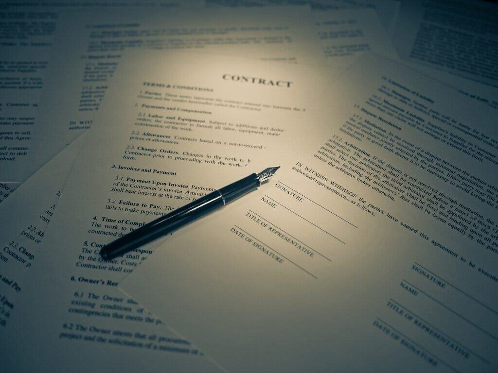 A printed document with a pen, representing long documents that can be summarized with AI prompts