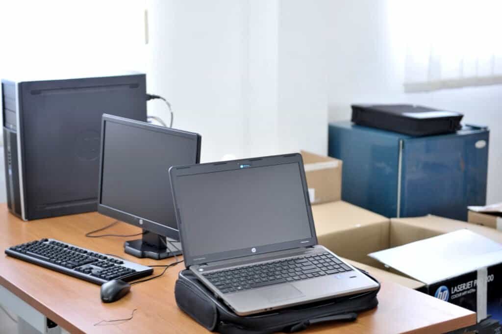 Laptop and desktop computer on a wooden office desk, representing building a landing page