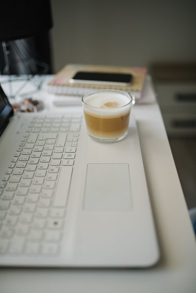 Coffee and laptop workspace setup for writing a quick daily stand-up update