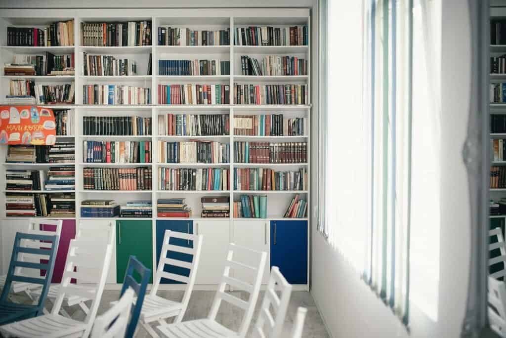 Rows of organized books on a library shelf, representing a well-maintained prompt library
