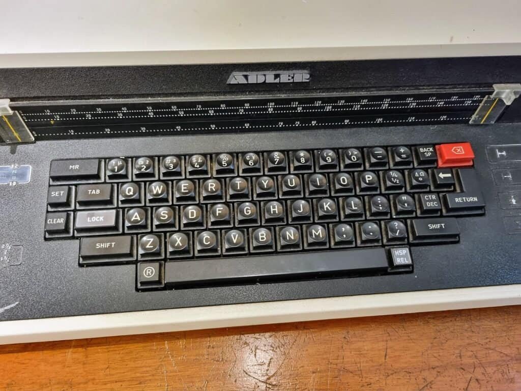 Close-up of mechanical typewriter keys, symbolizing how exact wording shapes AI prompt output