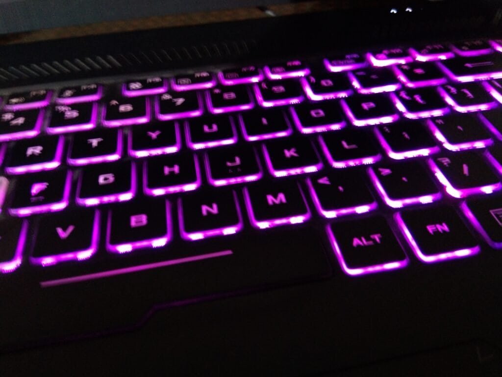 Close-up of a purple backlit keyboard, representing writing code and regular expressions