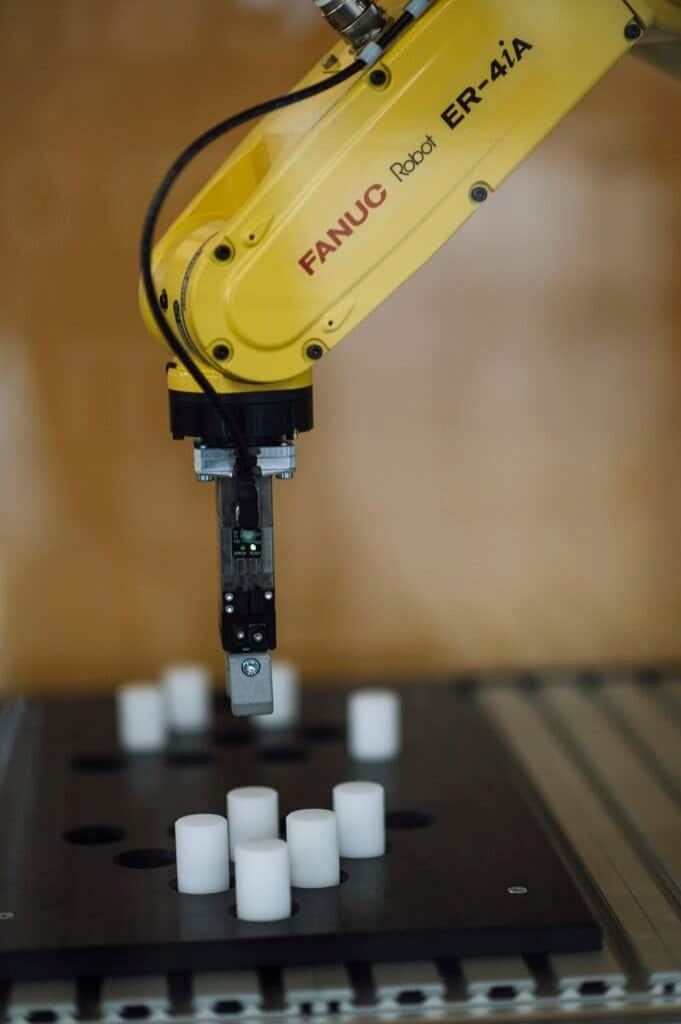 A robotic arm working in a factory, representing specialized AI agents collaborating on tasks