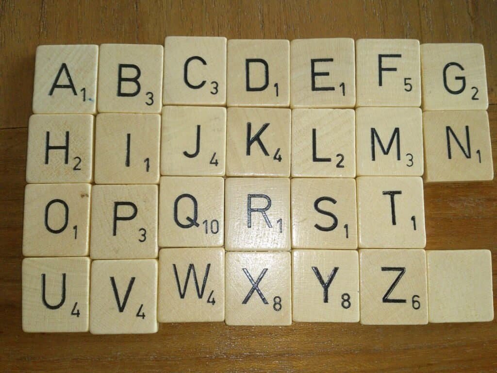 Individual letter tiles scattered on a surface, illustrating how AI language models break text into tokens