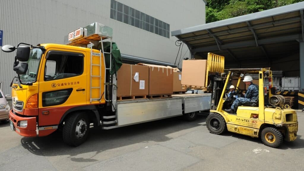 Warehouse worker handling product boxes, representing e-commerce product descriptions
