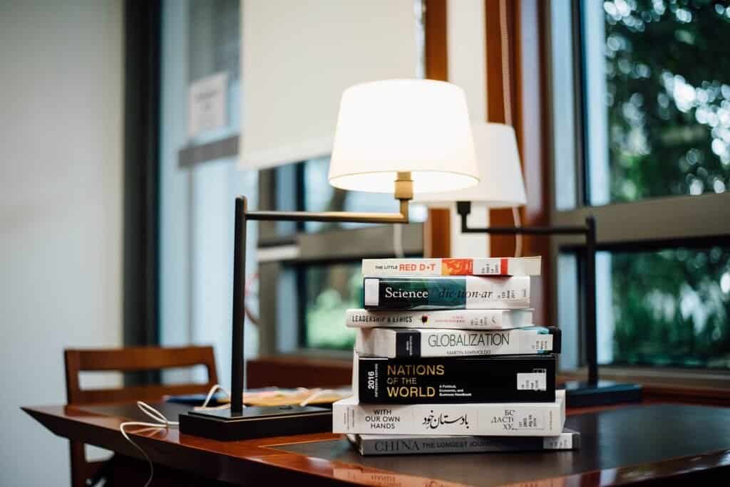 A stack of books on a table, representing how prompt compression condenses information into fewer tokens