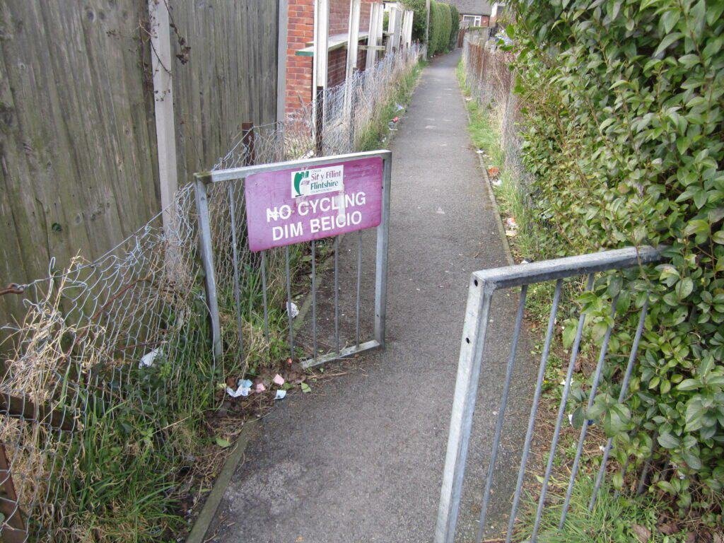 A bilingual street sign showing text in two different languages