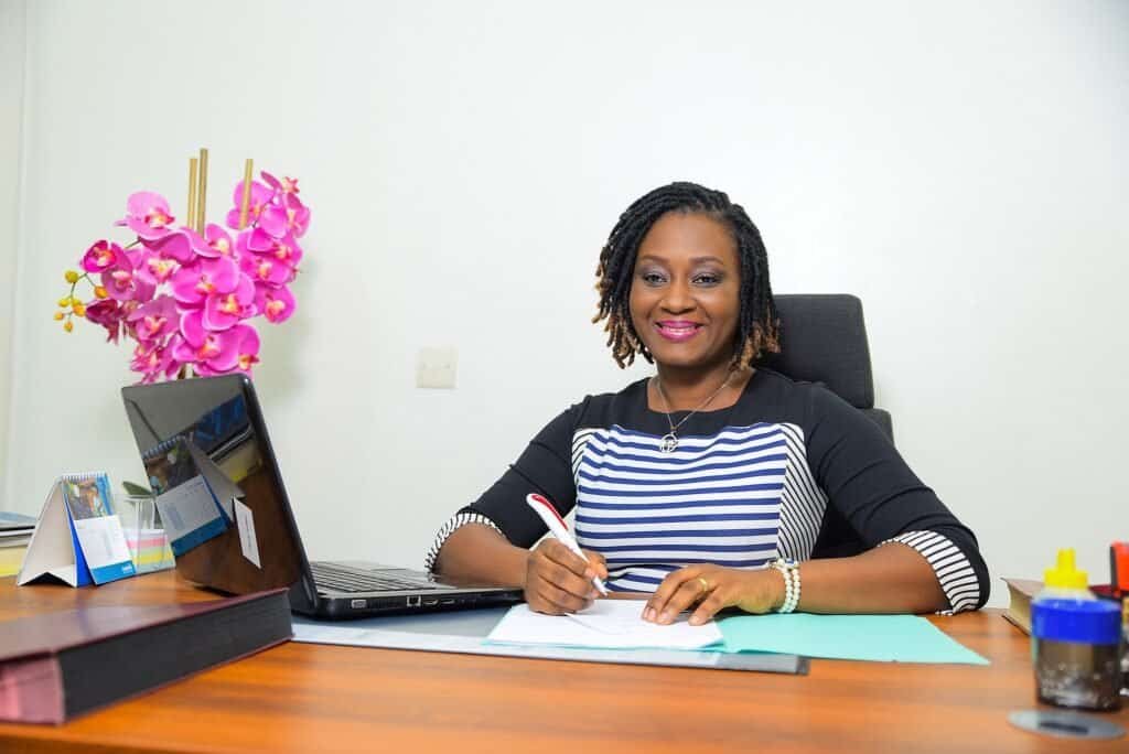 A businesswoman signing a contract, representing the moment a sales deal is won or lost