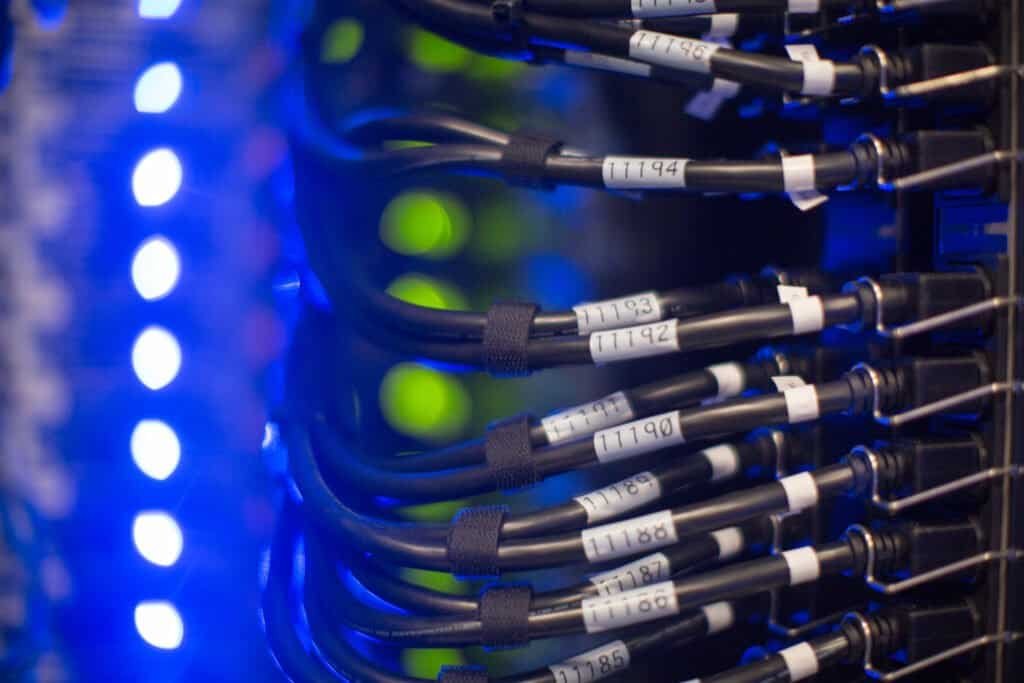 Close-up view of network cables and LED lights on servers in a data center