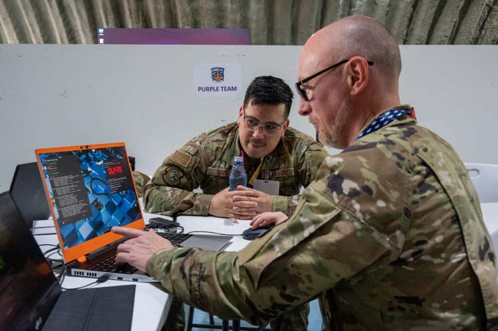 Military cyber operators working at computer stations during a cyber defense exercise