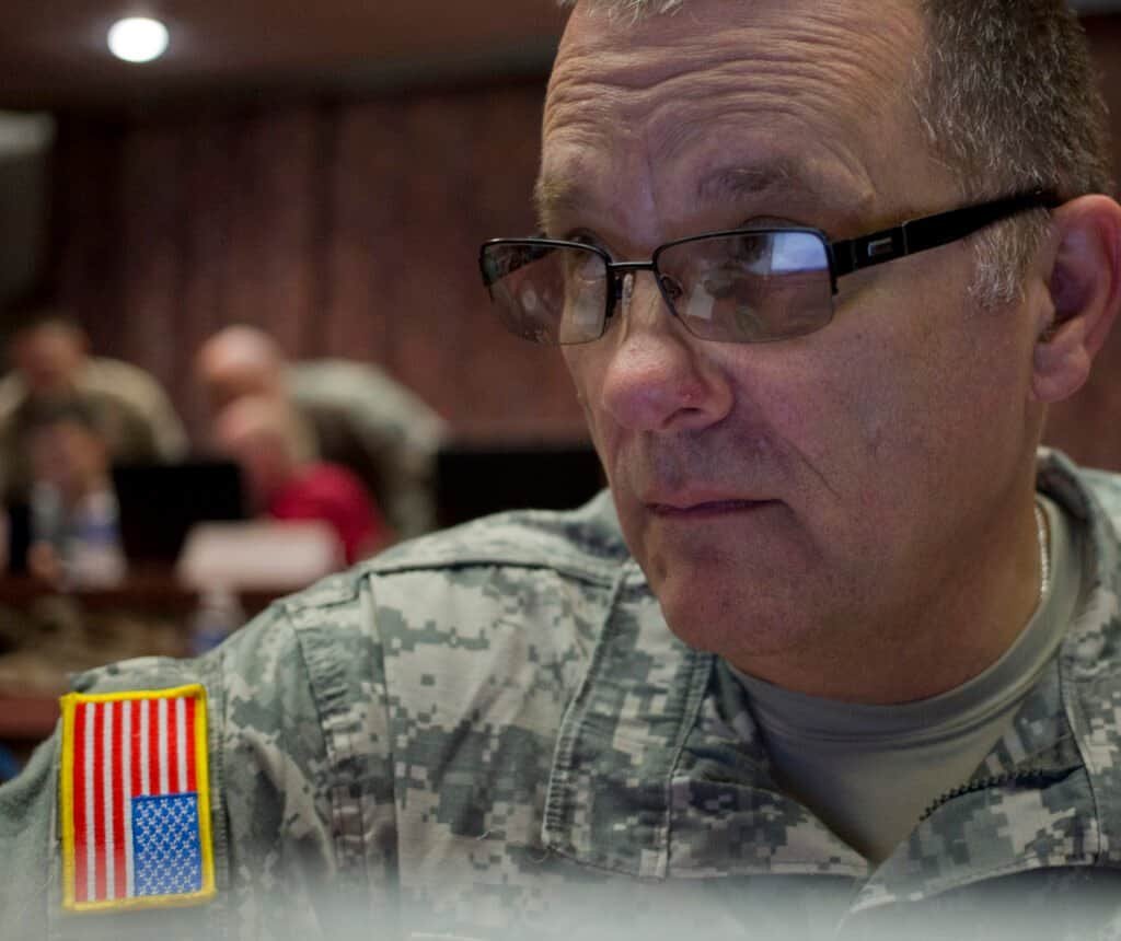 A soldier training on cyber security at a computer workstation