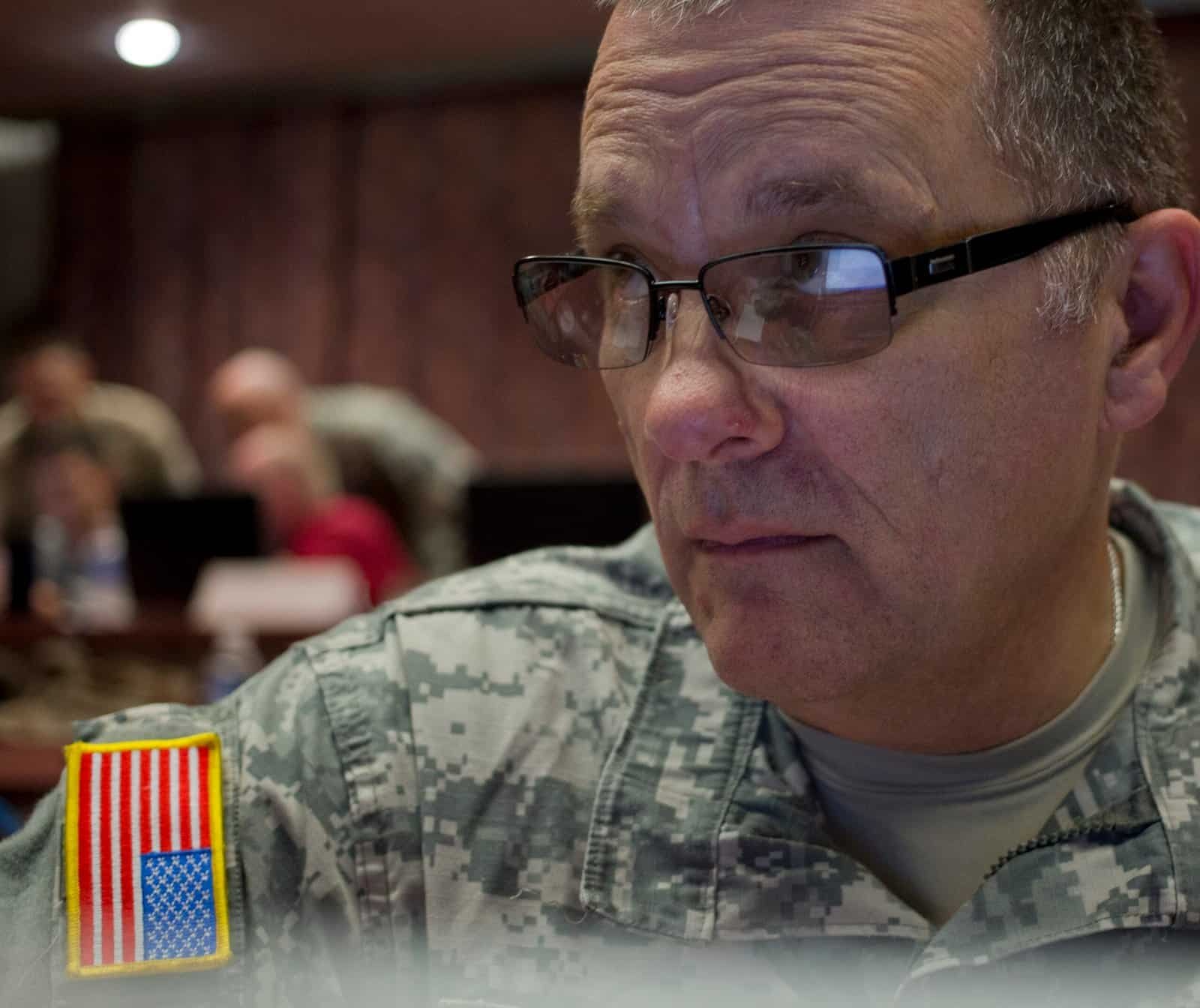 Cyber security specialist working at a computer A soldier training on cyber security at a computer workstation
