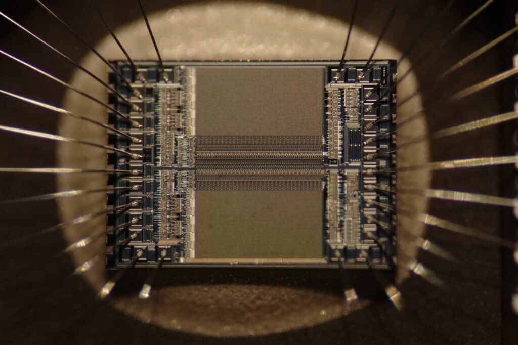 Macro photograph of an EPROM microchip die showing the integrated circuit and bonding wires