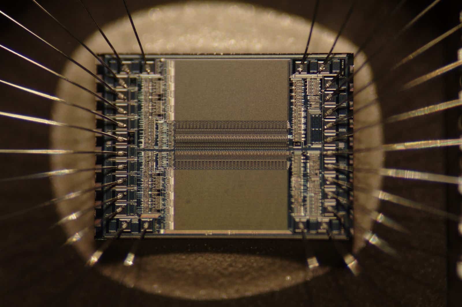 Macro photograph of an EPROM microchip die showing the integrated circuit and bonding wires