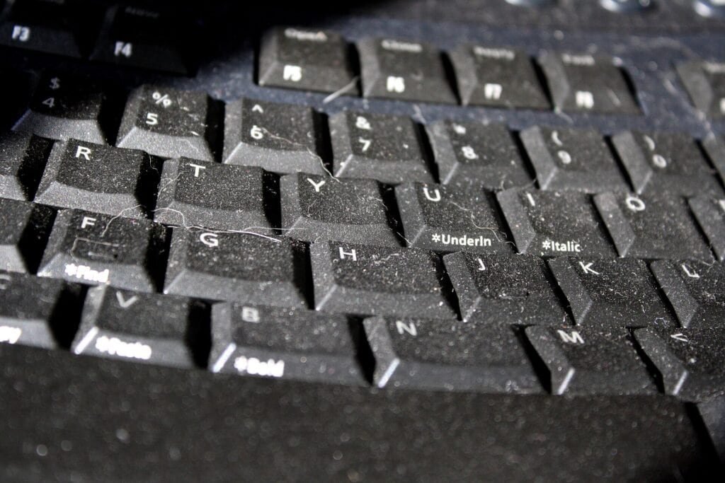A close-up of a computer keyboard, representing the code review step before an AI-generated regular expression merges.