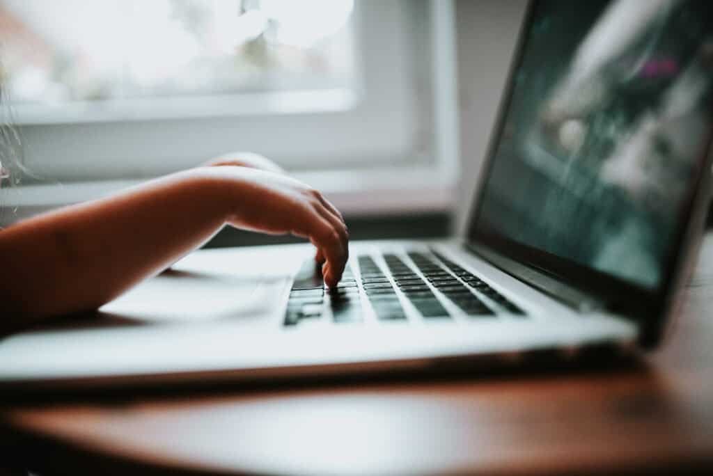 Close-up of hands typing on a laptop keyboard, representing an inbox automation workflow