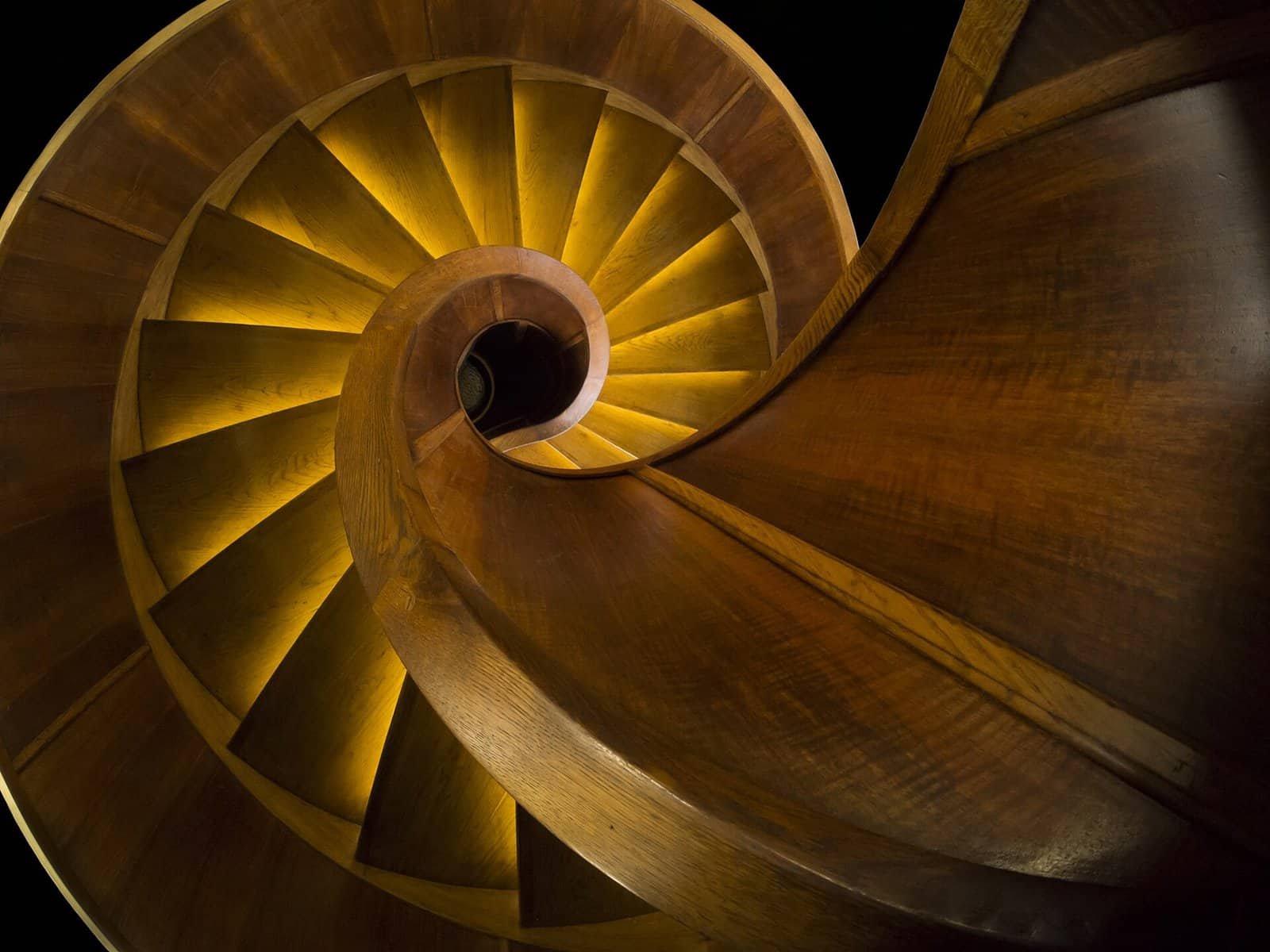 Spiral staircase representing step-by-step problem breakdown Spiral wooden staircase symbolizing breaking a problem into smaller sequential steps