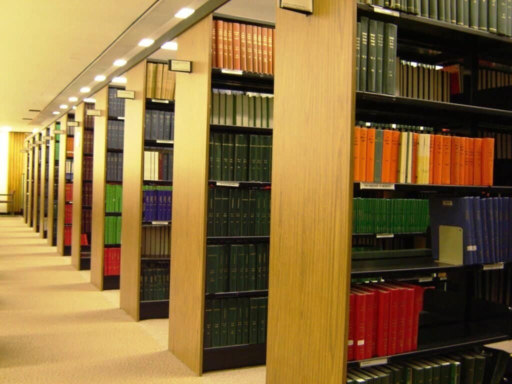 Rows of library bookshelves, used to illustrate the difference between a page being discovered and a page being indexed