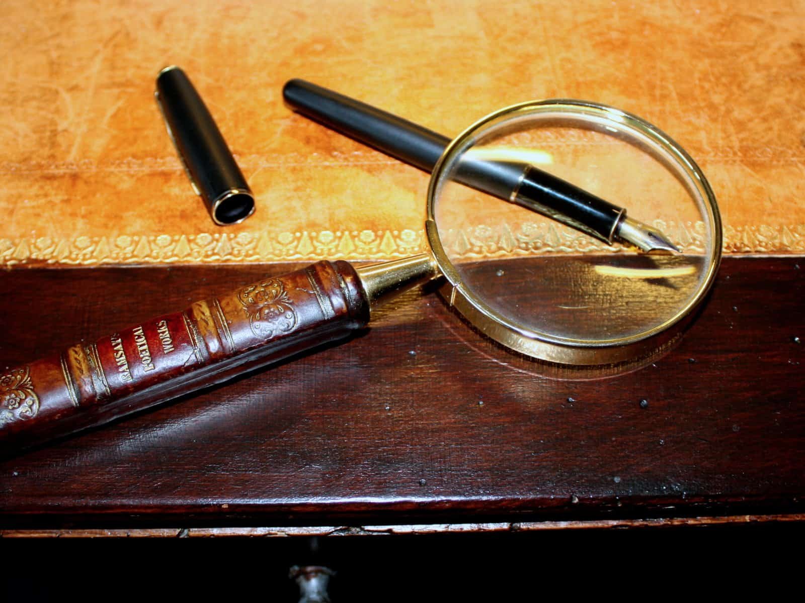 Magnifying glass on an antique table, used to illustrate verifying AI-generated claims against source text A magnifying glass resting on an antique wooden table, symbolizing close verification of text