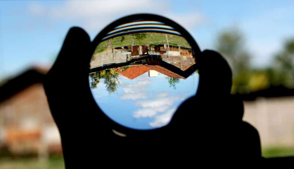 A convex magnifying lens, illustrating a close inspection of a page before deciding whether to keep its FAQ schema