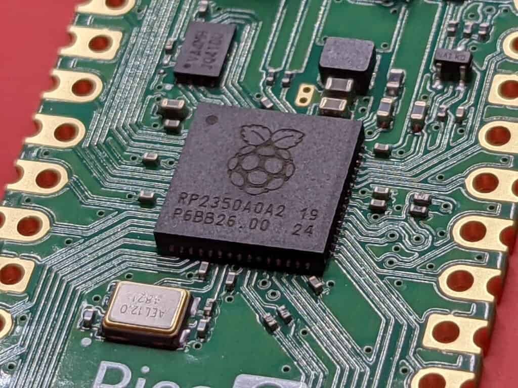Macro photograph of a populated microcontroller board, representing isolated, parallel hardware components