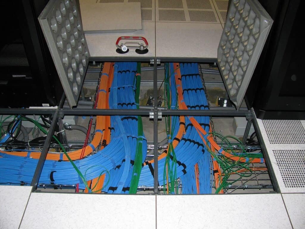 Multiple network cables running in parallel under a data center floor, representing several independent calls happening at once.