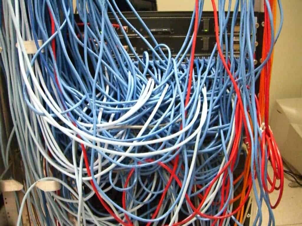 A tangled mass of network cables in a server rack, representing unconstrained model output before a schema is applied
