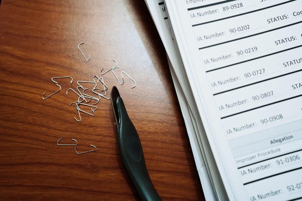 Stack of paper documents and office supplies, representing source documents used to ground an AI prompt