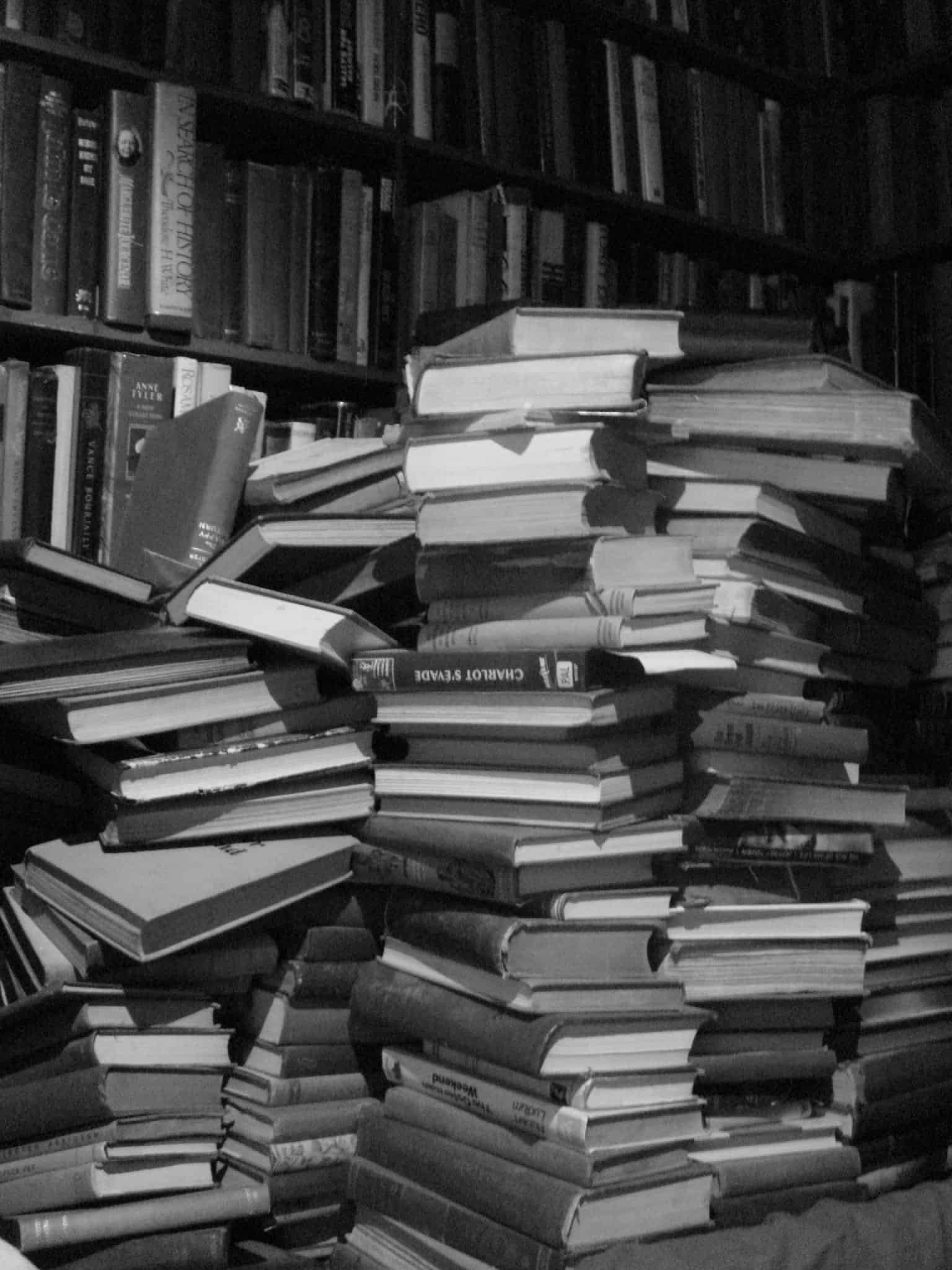 A stack of books, representing the long documents that push instructions toward the middle of a prompt A tall stack of books, illustrating how a long document in a prompt pushes other instructions toward the middle of the context window